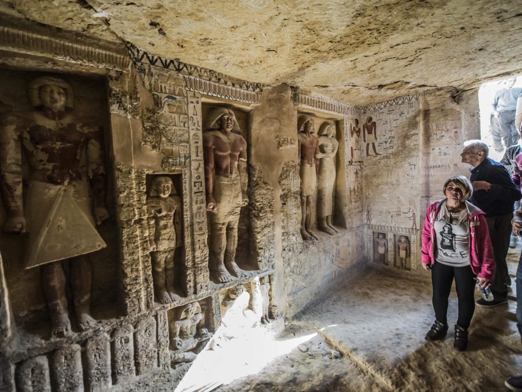 Visitors enter a newly-discovered Egyptian tomb at the Saqqara necropolis on Saturday. Visitors enter a newly-discovered Egyptian tomb at the Saqqara necropolis on Saturday. (Khaled Desouki/AFP/Getty Images)