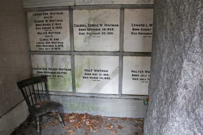 Walt Whitman is buried in a granite crypt set into a hillside in Harleigh Cemetery in Camden, along with several family members. (Emma Lee/WHYY)