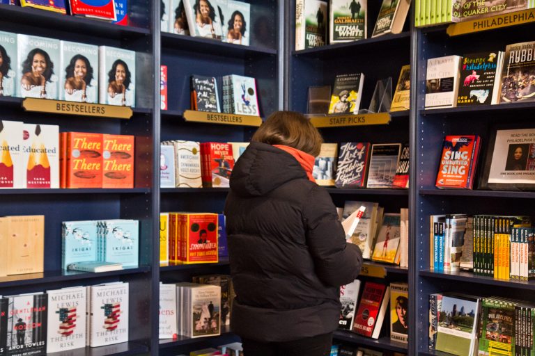 A customer browses the shelves at Shakespeare & Co. in Center City. (Kimberly Paynter/WHYY)