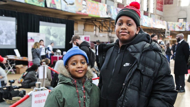 Justin Shuford , 8, (left) and his brother Darrion, 14, (right) participate in the MLK Day of Service at Girard College. (Kimberly Paynter/WHYY)