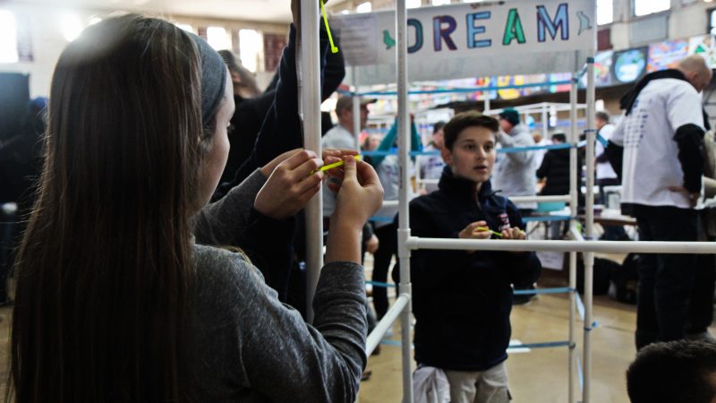 Kids construct booths at the Dream Booth banner project which will place booths in almost every city school. (Kimberly Paynter/WHYY)