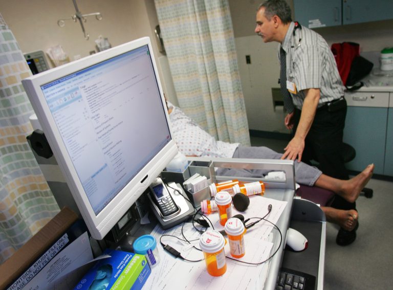 In this Feb. 23, 2010 photo, Dr. Jacob Khushigian checks on a patient who had overdosed with his portable computer data base shown in a Kaweah Delta Emergency Room in Visalia, Calif. (Gary Kazanjian/AP Photo)