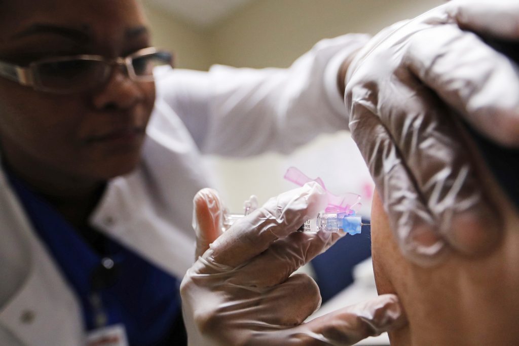 Claudina Prince Registered Nurse Claudina Prince administers a flu shot at a Dekalb County health center in Decatur, Ga., Monday, Feb. 5, 2018. (AP Photo/David Goldman)