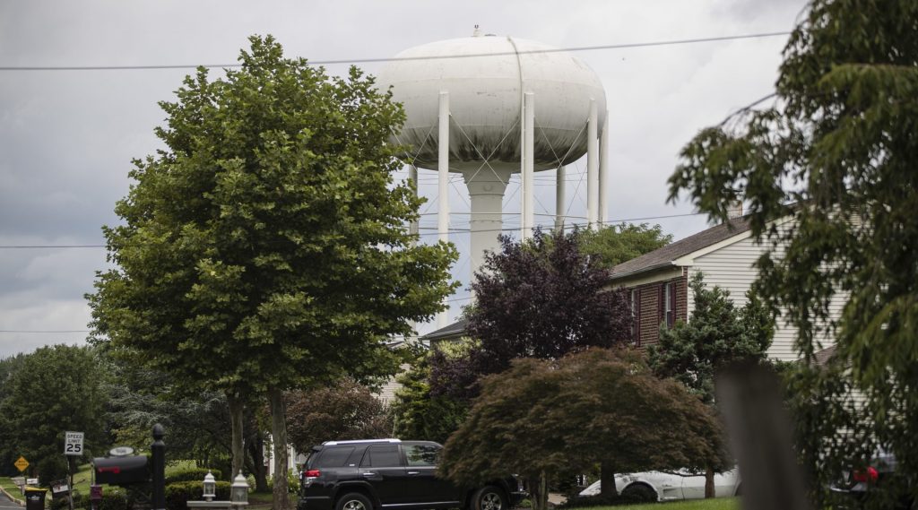 AP_18222604883108-e1548800293107-1920×1066 A water tower stands above a residential neighborhood