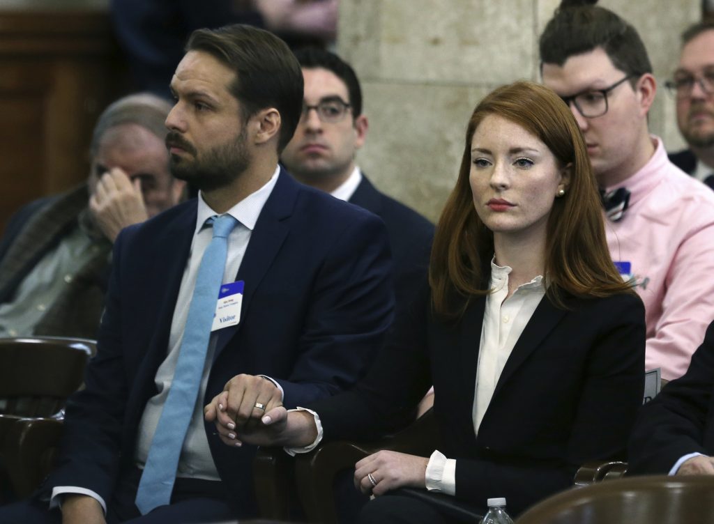 Sexual Misconduct New Jersey In this file photo, Katie Brennan, the chief of staff at the New Jersey Housing and Mortgage Finance Agency, holds hands with her husband Travis Miles as she waits to testify before the Select Oversight Committee at the Statehouse, Tuesday, Dec. 4, 2018, in Trenton, N.J. (Mel Evans/AP Photo)