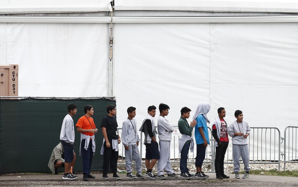 Immigration Childrens Shelters Migrant teens walk in a line at a shelter for unaccompanied children, on Monday, Dec. 10, 2018. (Brynn Anderson/AP Photo)