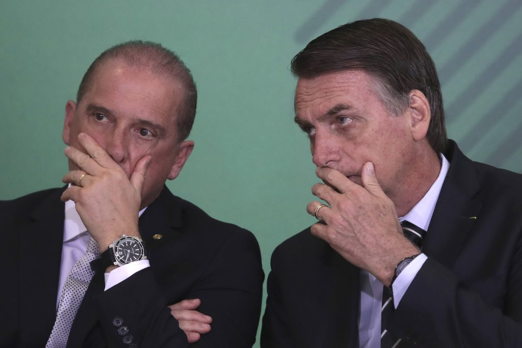 Brazil's President Jair Bolsonaro, (right), talks with his Chief of Staff Onyx Lorenzoni during a cabinet presentation ceremony at the presidential palace in Brasilia, Brazil, Wednesday, Jan. 2, 2019. (Eraldo Peres/AP Photo)