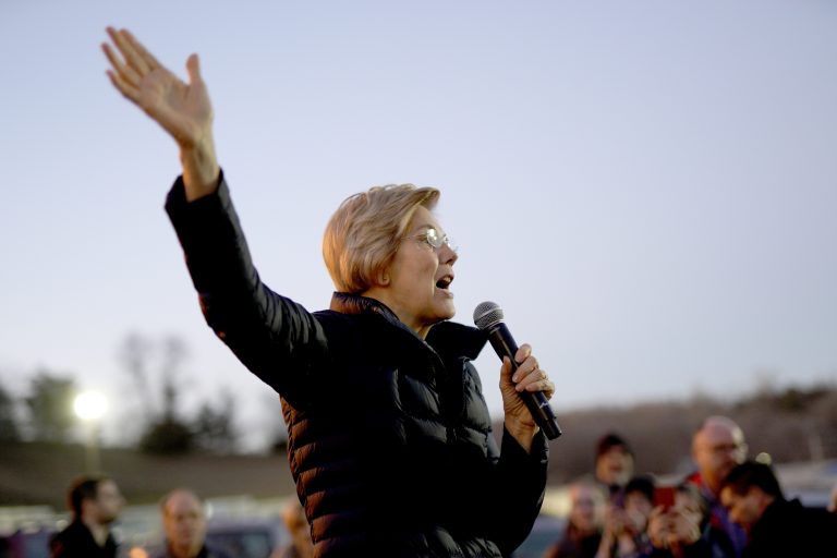 AP_19005043848571-768×512 Sen. Elizabeth Warren, D-Mass, addresses an overflow crowd outside an organizing event at McCoy's Bar Patio and Grill in Council Bluffs, Iowa, Friday, Jan. 4, 2019. (Nati Harnik/AP Photo)