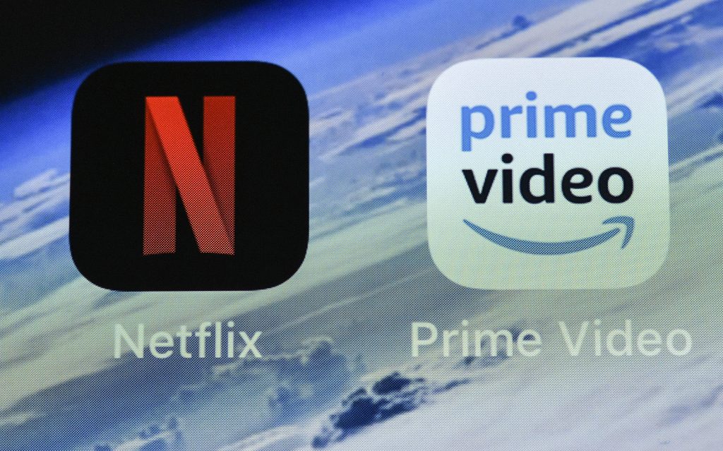 New Age of Streaming In this Thursday, Nov. 15, 2018 file photo, the icons of streaming services Netflix and AmazonPrime Video are pictured on an iPhone in Gelsenkirchen, Germany. Streaming your favorite movies and TV shows is about to get way more expensive. Amazon Prime customers can add-on subscriptions to HBO, Showtime or Starz. (Martin Meissner/AP Photo, File)