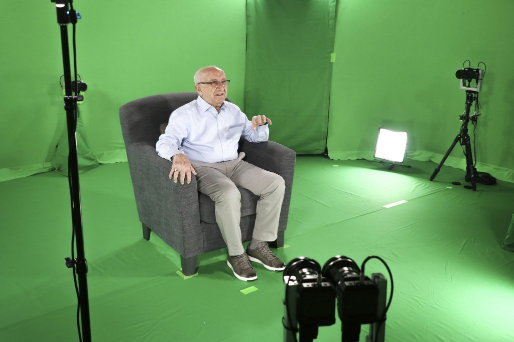 Interactive Holocaust Testimonies This August 2018 photo shows Holocaust survivor Max Glauben sitting in an interactive green screen room while filming a piece for the Dallas Holocaust Museum in Dallas. (McGuire Boles/Dallas Holocaust Museum via AP)