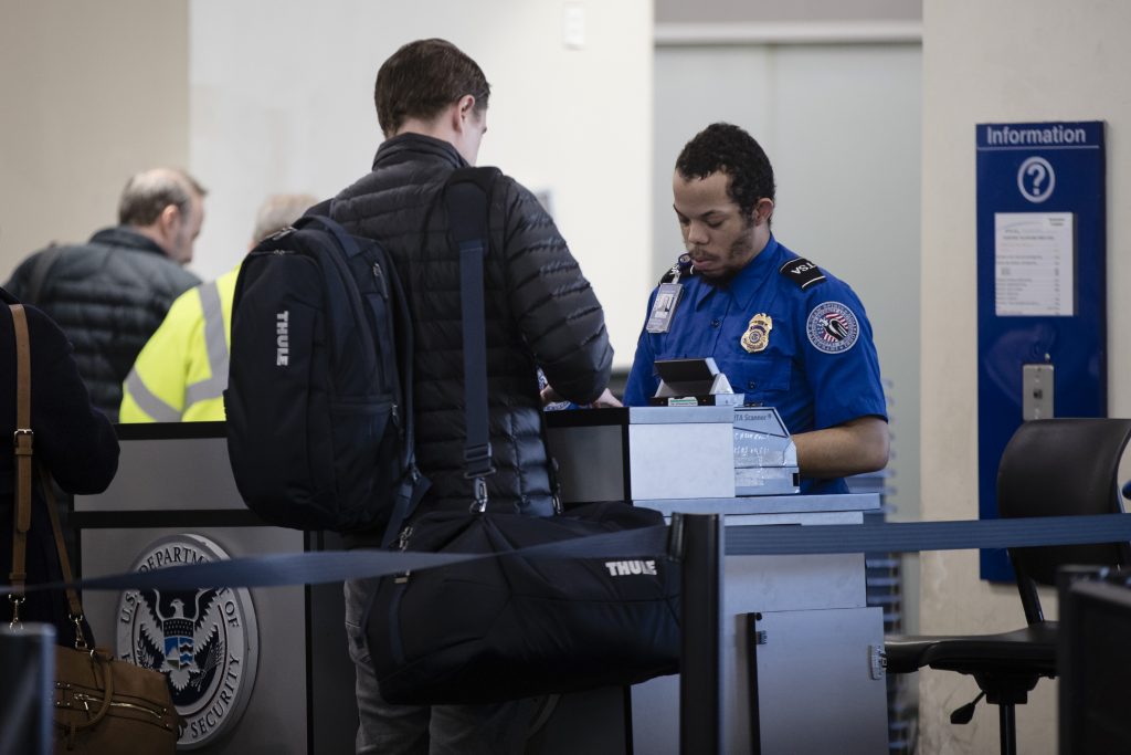 Government Shutdown Airports A Transportation Security Administration official works at the entrance to a gate at the Philadelphia International Airport in Philadelphia, Friday, Jan. 11, 2019. (AP Photo/Matt Rourke)