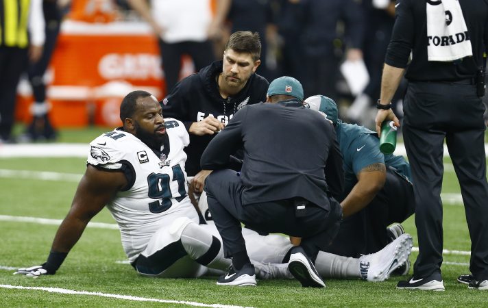 Philadelphia Eagles defensive tackle Fletcher Cox (91) is helped after injury against the New Orleans Saints in the first half of an NFL divisional playoff football game in New Orleans, Sunday, Jan. 13, 2019. (AP Photo/Butch Dill)