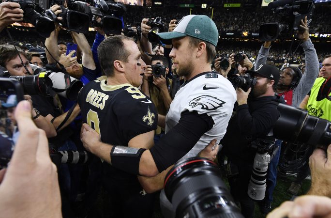 New Orleans Saints quarterback Drew Brees (9) speaks with Philadelphia Eagles quarterback Nick Foles after an NFL divisional playoff football game in New Orleans, Sunday, Jan. 13, 2019. The Saints won 20-14 to advance to the NFC Championship. (AP Photo/Bill Feig)
