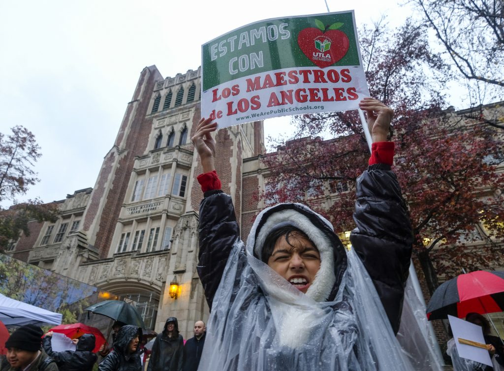 APTOPIX Los Angeles Teachers Strike Alessandro Niculescu, 10, holds up a sign in the rain during a teacher strike outside John Marshall High School, Monday, Jan. 14, 2019, in Los Angeles. Tens of thousands of Los Angeles teachers are striking after contentious contract negotiations failed in the nation's second-largest school district.(Ringo H.W. Chiu/AP)