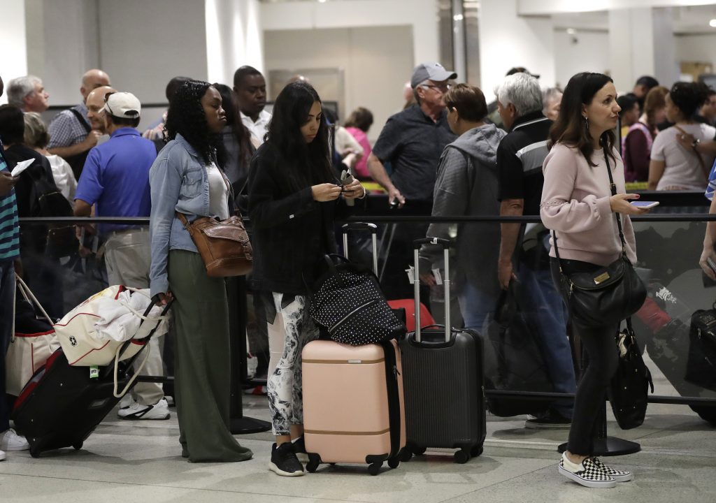 Government Shutdown Everyday Effects In this Jan. 18, 2019, file photo passengers wait in line at a security checkpoint at Miami International Airport in Miami. While security screeners and air traffic controllers have been told to keep working, Federal Aviation Administration safety inspectors weren’t, until the agency began recalling some Jan. 12. About 2,200 of the more than 3,000 inspectors are now back on the job, overseeing work done by airlines, aircraft manufacturers and repair shops. The government says they’re doing critical work but forgoing such tasks as issuing new pilot certificates. (Lynne Sladky, AP)