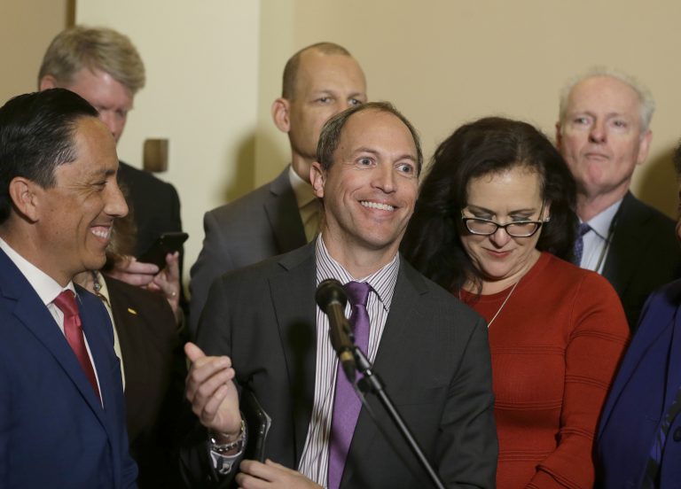  In this Jan. 24, 2019 file photo, Assemblyman Brian Maienschein, center, smiles at a news conference where he announced he was switching party registration from Republican to Democrat, in Sacramento, 
 California (Rich Pedroncelli/AP)