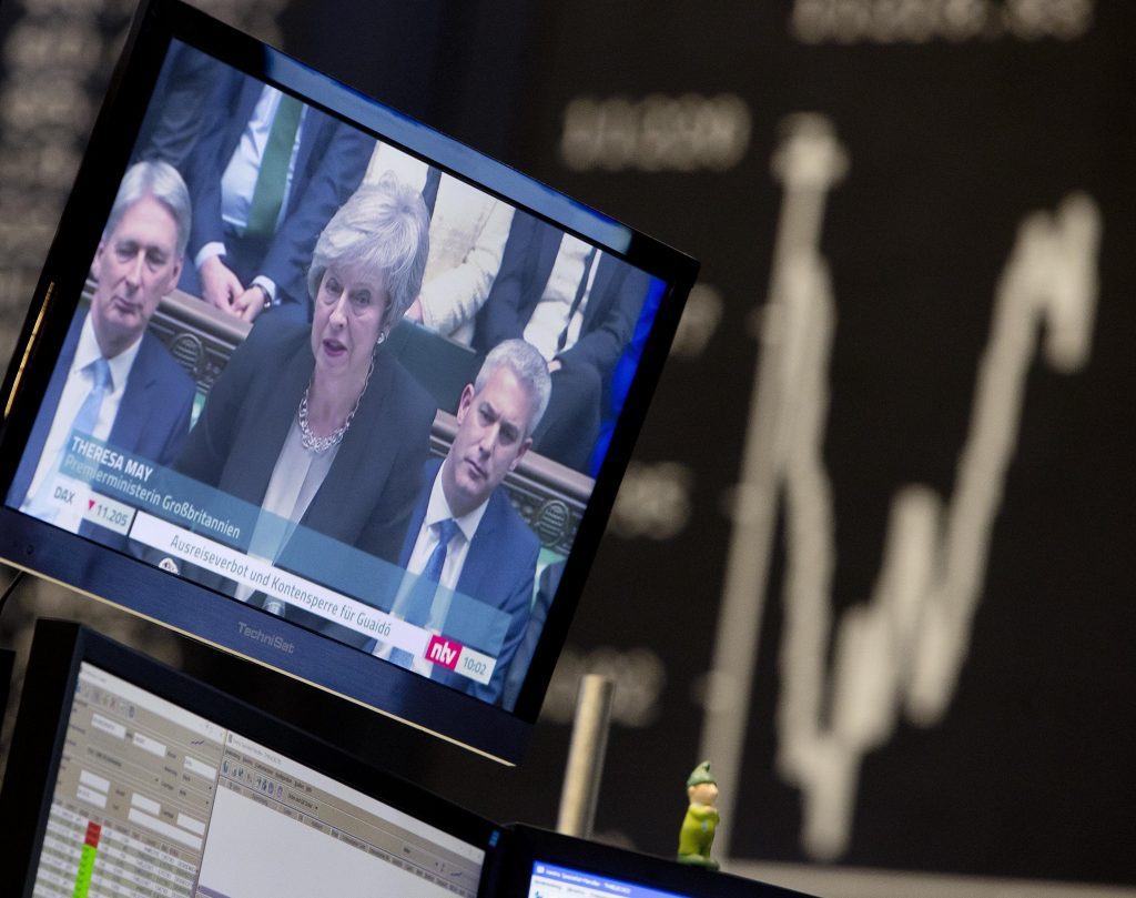 APTOPIX Germany Brexit News about the Brexit are seen on a television screen with the curve of the German stock index DAX in background at the stock market in Frankfurt, Germany, Wednesday, Jan. 30, 2019. (Michael Probst/AP Photo)