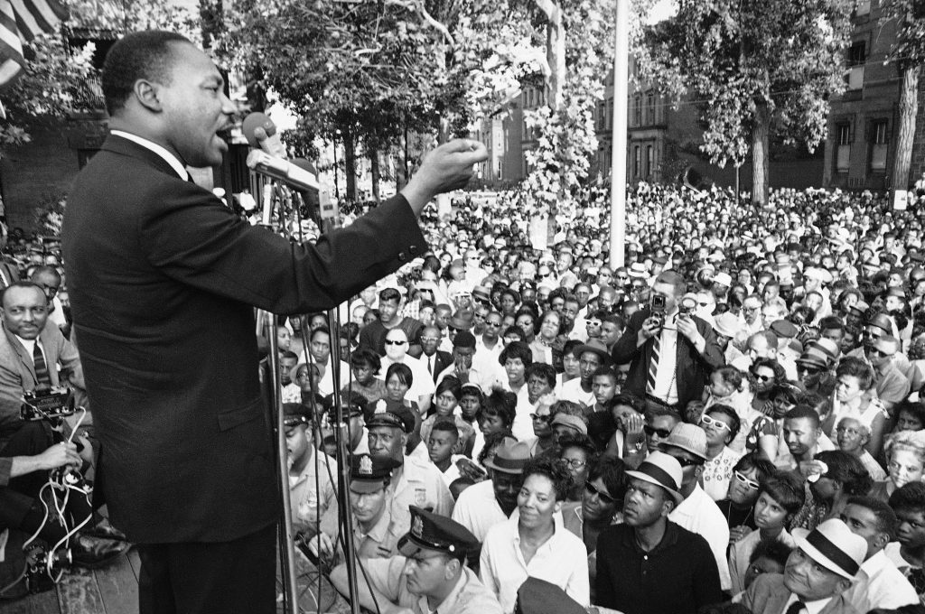 Dr. Martin Luther King Speaking A line of police stands in front of platform from which Dr. Martin Luther King speaks during mass meeting in front of all-white Girard College in Philadelphia August 4, 1965. Dr. King said the wall surrounding the school was a symbol of evil and called for continued efforts to integrate the school.