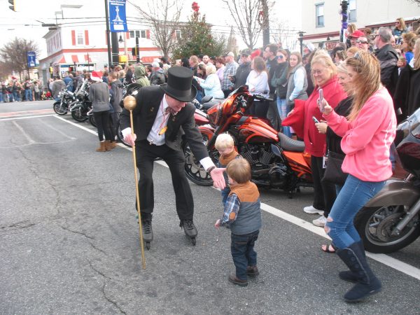 Jack Schreppler led the parade the whole way. He greets folks at the turn on to Main Street. (John Mussoni/WHYY)