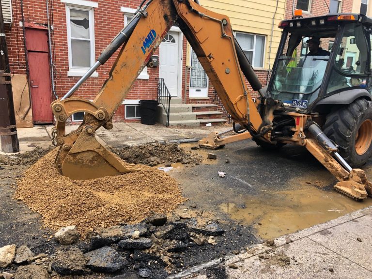 A Philadelphia Water Department crew completed the fix of a water main break in South Philadelphia as the department steps up efforts to manage water main breaks during the winter. (Darryl Murphy/WHYY)
