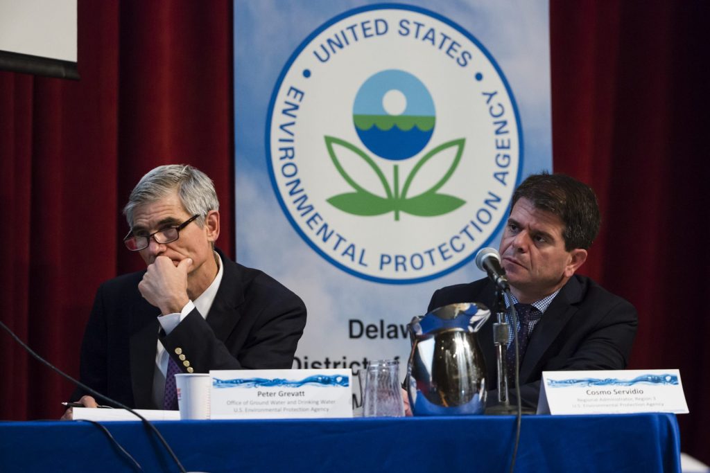 PFAS-EPA-hearing-1920×1280 In this July 25, 2018 photo US EPAs Peter Grevatt, Director of the Office of Ground Water and Drinking Water and Cosmo Servidio, Regional Administrator for the Mid-Atlantic Region, listen to members of the public comment during a PFAS Community Stakeholder Meeting, on in Horsham, Pa. In Horsham and surrounding towns in eastern Pennsylvania, and at other sites around the United States, the foams once used routinely in firefighting training at military bases contained per-and polyfluoroalkyl substances, or PFAS. EPA testing between 2013 and 2015 found significant amounts of PFAS in public water supplies in 33 U.S. states. (AP Photo/Matt Rourke)