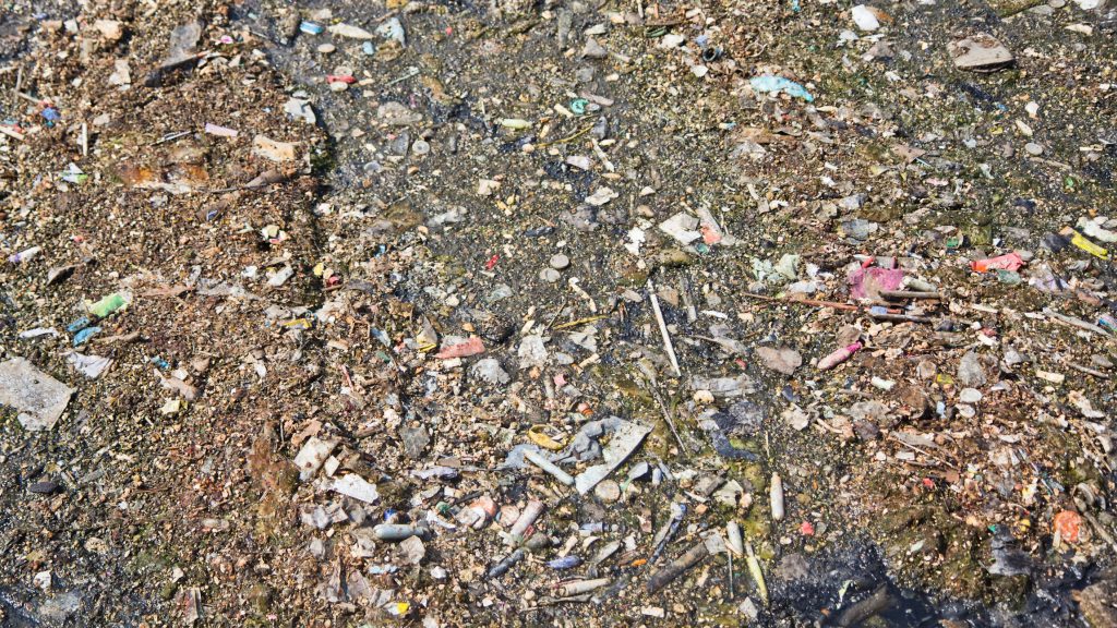 Plastic debris, including tampon applicators and straws, floats on top of sewage and stormwater at the Southwest water pollution control plant in Philadelphia. Water department officials recommend not flushing anything down the toilet except toilet paper. (Kimberly Paynter/WHYY)