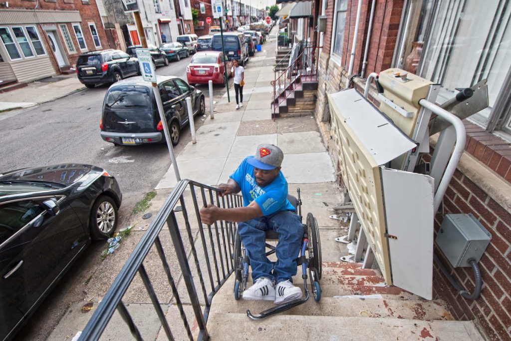 RODNEYXXP-R Rodney Whitmore of South Philadelphia was shot and paralyzed in 1995. When his wheelchair lift is broken, he tilts his wheelchair backward and lowers himself down his front steps so he can get to work.