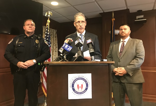 Stedman – cropped Lancaster County District Attorney Craig Stedman, center, speaks to reporters Dec. 6, 2018 about the October 26 multi-vehicle crash that killed two Warwick High School students. At left is Lititz Borough Police Chief Kerry Nye. At right, Lancaster County Assistant District Attorney Jared Hinsey. (Brett Sholtis/WITF News)