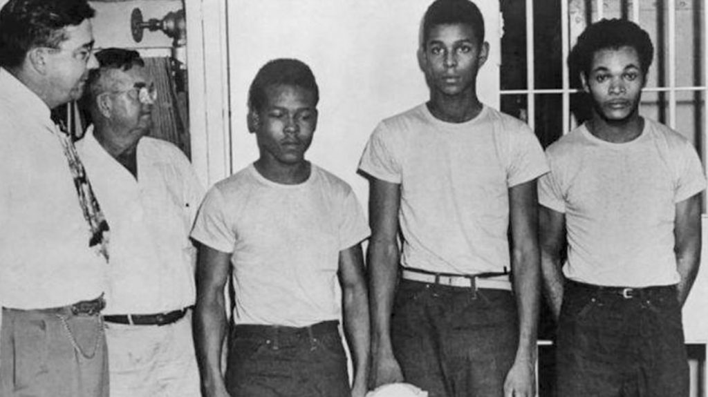(From left) Lake County, Fla., Sheriff Willis McCall and an unidentified man stand next to Walter Irvin, Samuel Shepherd and Charles Greenlee. The three were accused of rape in 1949, along with a fourth man. They were all pardoned Friday. (From left) Lake County, Fla., Sheriff Willis McCall and an unidentified man stand next to Walter Irvin, Samuel Shepherd and Charles Greenlee. The three were accused of rape in 1949, along with a fourth man. They were all pardoned Friday. (State Library and Archives of Florida via AP)