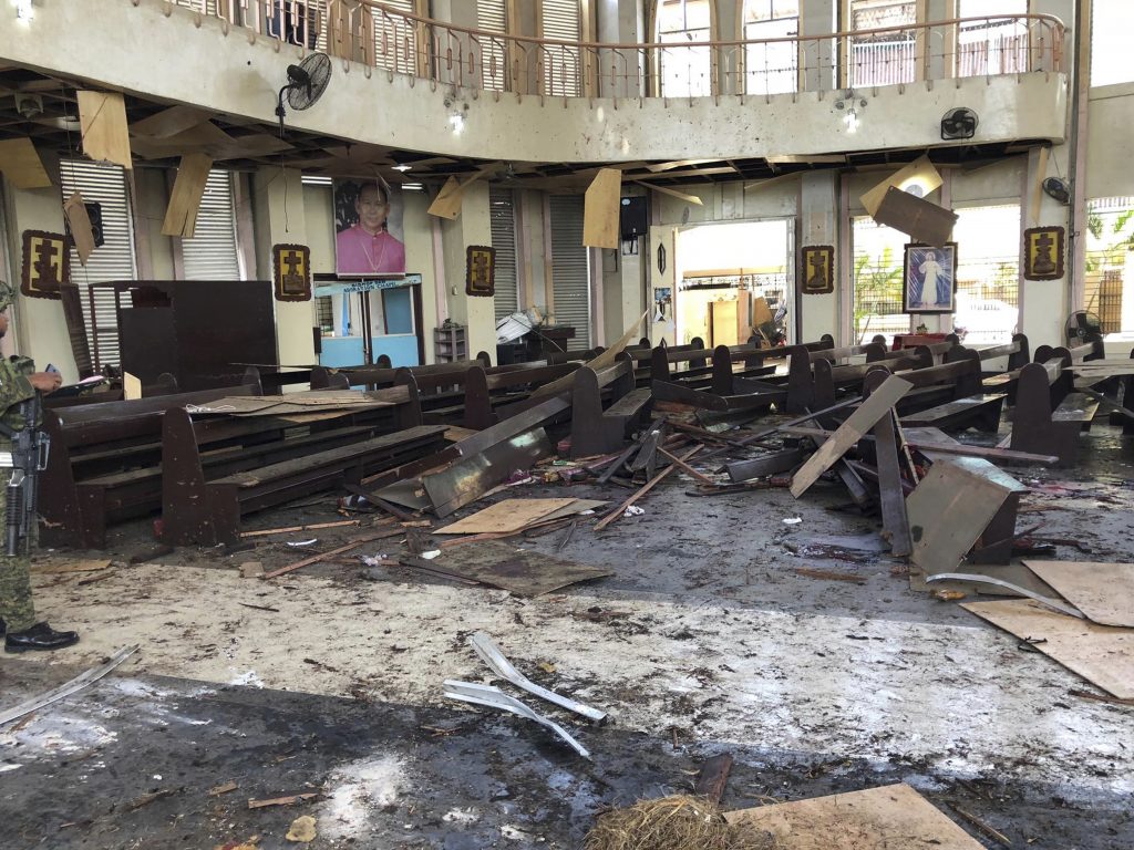 The Philippine government says it will “pursue to the ends of the earth the ruthless perpetrators” behind bomb attacks that killed at least 20 people and wounded many more during a Sunday Mass at a cathedral in Jolo. (WESMINCOM Armed Forces of the Philippines/AP) The Philippine government says it will