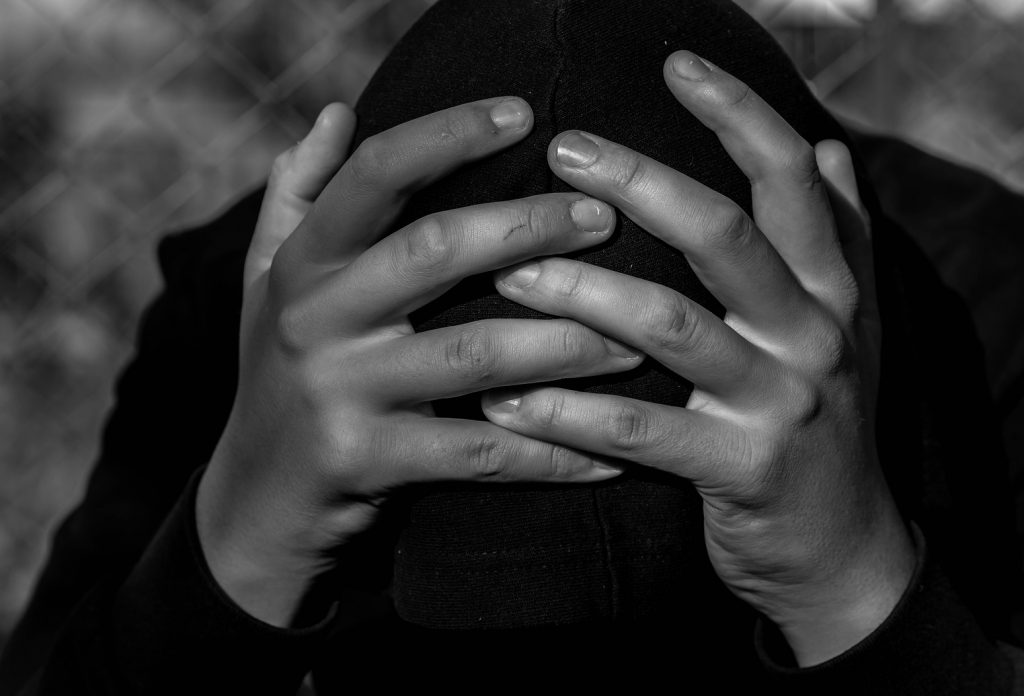 Young Unidentifiable Teenage Boy Holding Hes Head At The Correc Rutgers-Camden study pinpoints childhood trauma as likely source of anxiety, depression and suggests healthy family life, civic engagement can mitigate problems (Benedek Alpar/BigStock)