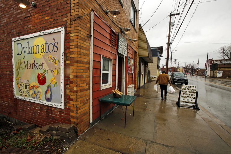 In this March 1, 2018 photo, a customer leaves Dylamatos Market owned by Dianne Shenk in the Hazelwood neighborhood of Pittsburgh. About a quarter of Shenk's customers pay with benefits from the federal Supplemental Nutrition Assistance Program. (Gene J. Puskar/AP)