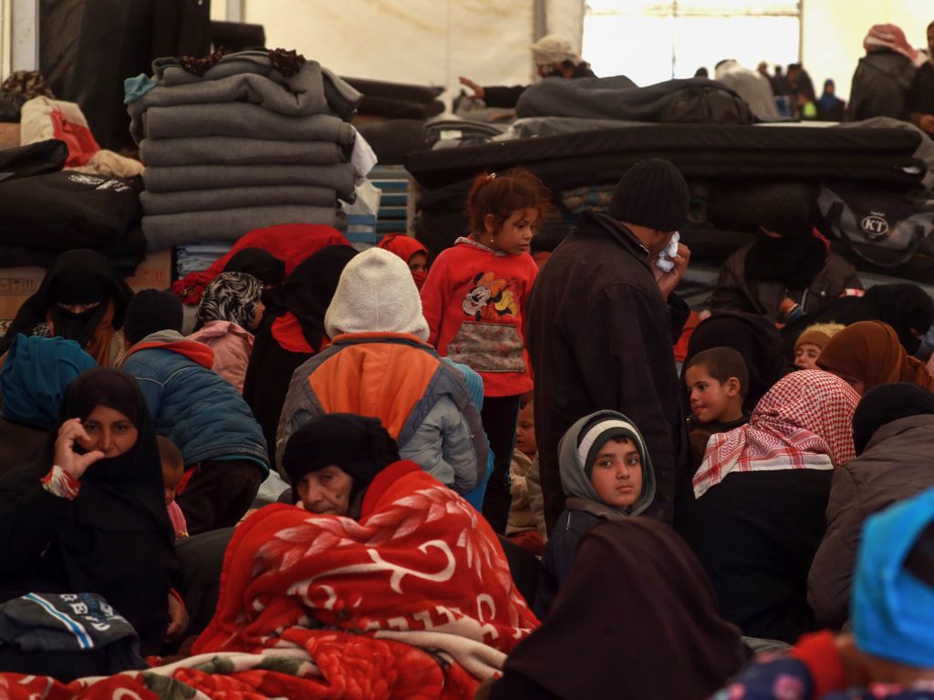 Displaced Syrians gather inside a tent in the al-Hol camp in northeastern Syria on Dec. 8. People fled towns where the U.S.-led coalition is fighting the last remnants of ISIS. Displaced Syrians gather inside a tent in the al-Hol camp in northeastern Syria on Dec. 8. People fled towns where the U.S.-led coalition is fighting the last remnants of ISIS. (Delil Souleiman/AFP/Getty Images)