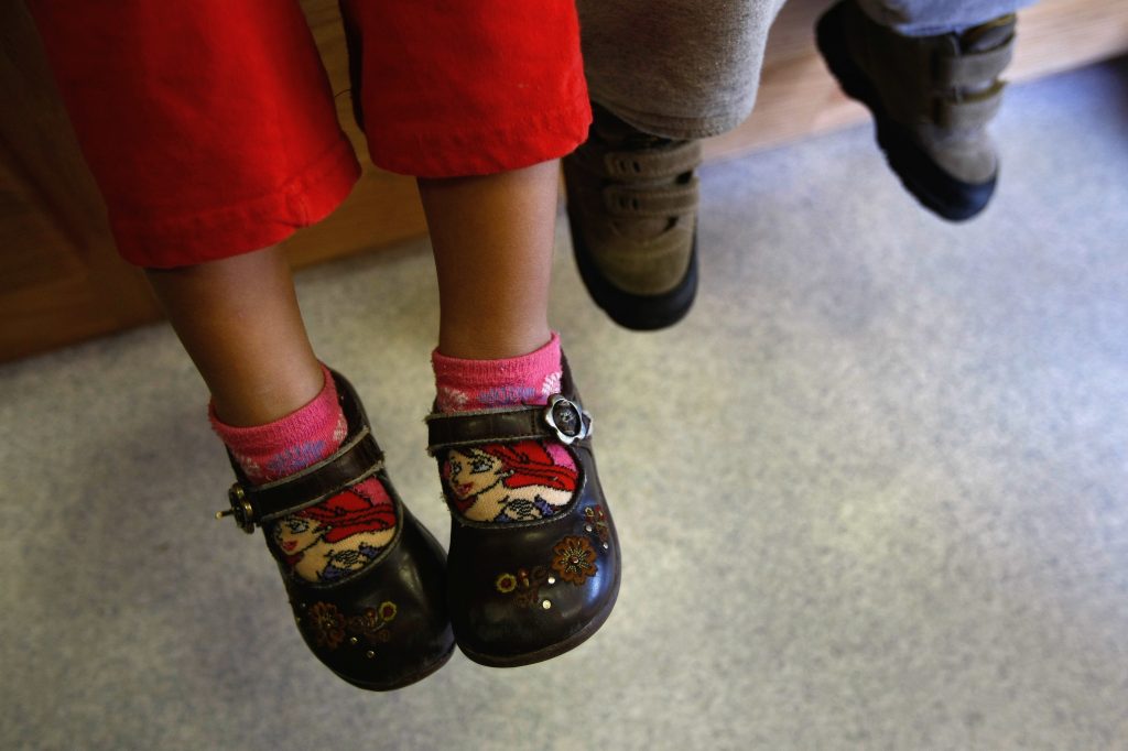 Children of Mexican immigrants wait to receive a free health checkup inside a mobile clinic at the Mexican Consulate in Denver, Colo., in 2009. The Trump administration wants to ratchet up scrutiny of the use of social services by immigrants. That’s already led some worried parents to avoid family health care. Children of Mexican immigrants wait to receive a free health checkup inside a mobile clinic at the Mexican Consulate in Denver, Colo., in 2009. The Trump administration wants to ratchet up scrutiny of the use of social services by immigrants. That's already led some worried parents to avoid family health care.
(John Moore/Getty Images)