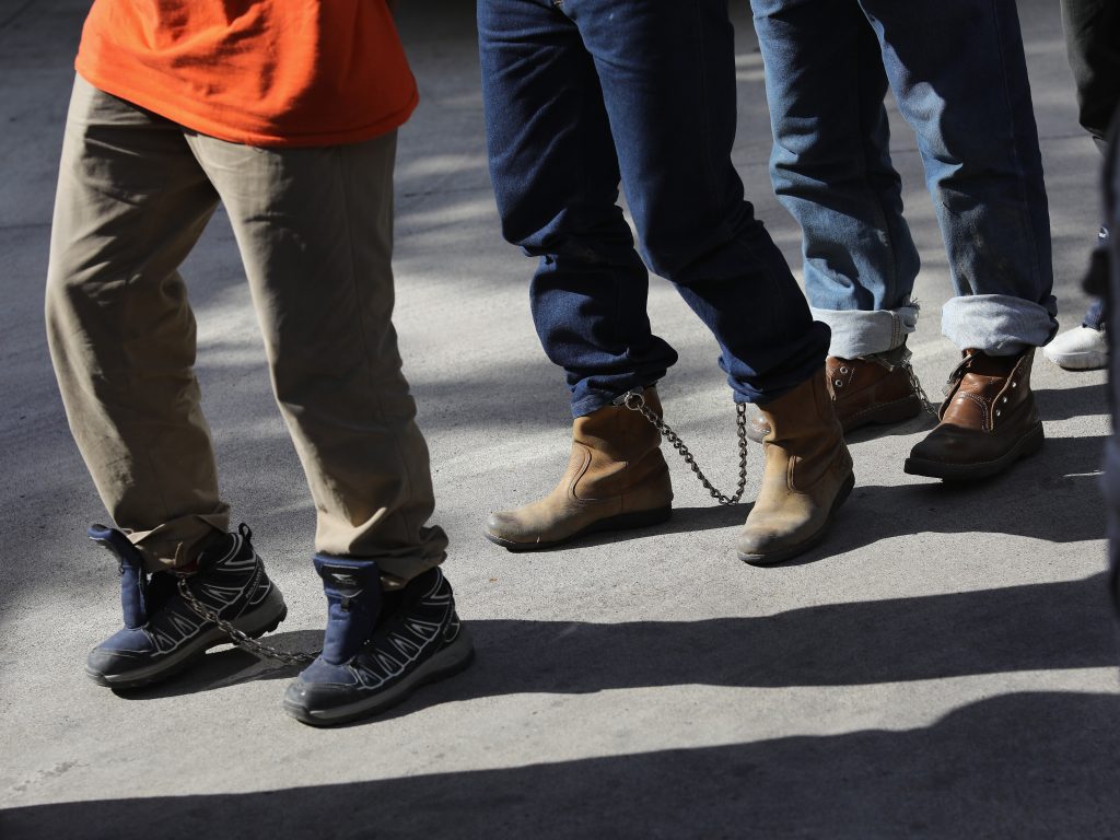 Unauthorized immigrants leave a court in shackles in McAllen, Texas. More than 40,000 immigration court hearings have been canceled since the government shut down. Unauthorized immigrants leave a court in shackles in McAllen, Texas. More than 40,000 immigration court hearings have been canceled since the government shutdown (John Moore/Getty Images)