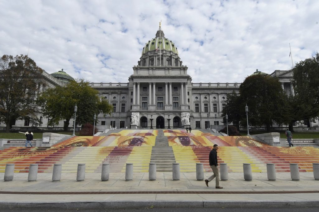 Pennsylvania Daily Life The steps of the Pennsylvania state Capitol are seen on Wednesday, Oct. 31, 2018, in Harrisburg, Pa., covered with an art installation by Michelle Angela Ortiz showing images of young mothers who were held in a facility in Pennsylvania that is one of three family detention centers in the United States that holds children and parents who are seeking asylum or entered the country illegally. (AP Photo/Marc Levy)
