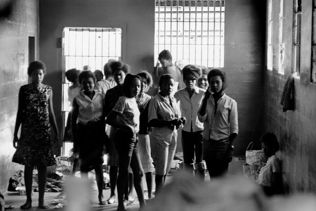 In August 1963, African-American girls were held in a Georgia stockade after being arrested for demonstrating segregation. Left to right: Melinda Jones Williams (13), Laura Ruff Saunders (13), Mattie Crittenden Reese, Pearl Brown, Carol Barner Seay (12), Annie Ragin Laster (14), Willie Smith Davis (15), Shirley Green (14), and Billie Jo Thornton Allen (13). Sitting on the floor: Verna Hollis (15). In August 1963, African-American girls were held in a Georgia stockade after being arrested for demonstrating segregation. Left to right: Melinda Jones Williams (13), Laura Ruff Saunders (13), Mattie Crittenden Reese, Pearl Brown, Carol Barner Seay (12), Annie Ragin Laster (14), Willie Smith Davis (15), Shirley Green (14), and Billie Jo Thornton Allen (13). Sitting on the floor: Verna Hollis (15). (Danny Lyon)