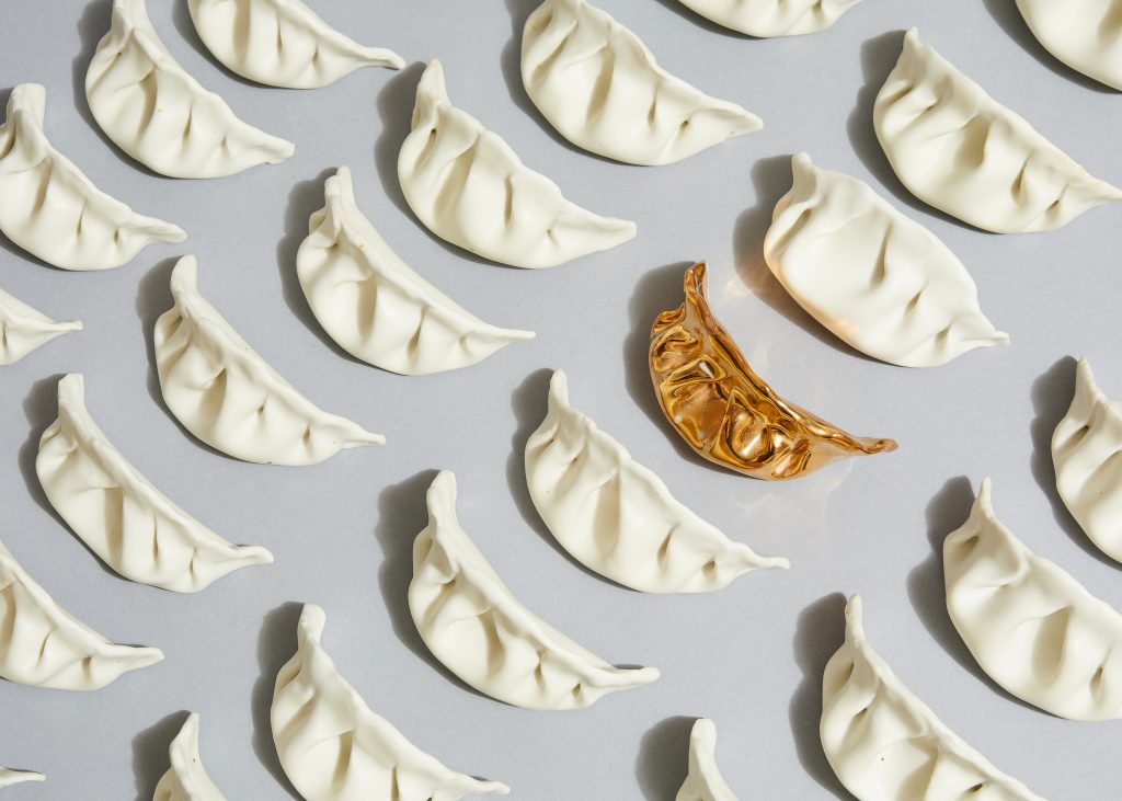 Artist Stephanie Shih remembers making pork-filled dumplings with her family and started her art project by sculpting six of them out of porcelain. She’s now made 600. Artist Stephanie Shih remembers making pork-filled dumplings with her family and started her art project by sculpting six of them out of porcelain. She's now made 600. (Robert Bredvad/NPR)