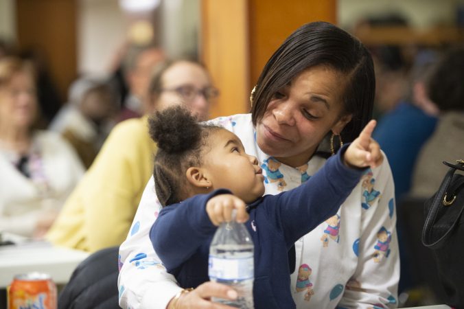 Antoinette Reynolds plays with granddaughter Ma'Leiyah Whitney-Barnes at Uneven Play: A Community Dinner and Conversation held at St. Pauls Lutheran Church in Olney. (Jonathan Wilson for WHYY)