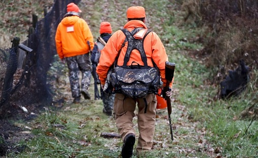 Santo Cerminaro, (right), follows his son, Dominick Cerminaro, (left), and grandson, Santo Cerminaro, 11, into the woods to go deer hunting on the first day of regular firearms deer hunting season, in most of Pennsylvania, Monday, Nov. 26, 2018 in Zelienople, Pa. (Keith Srakocic/AP Photo)