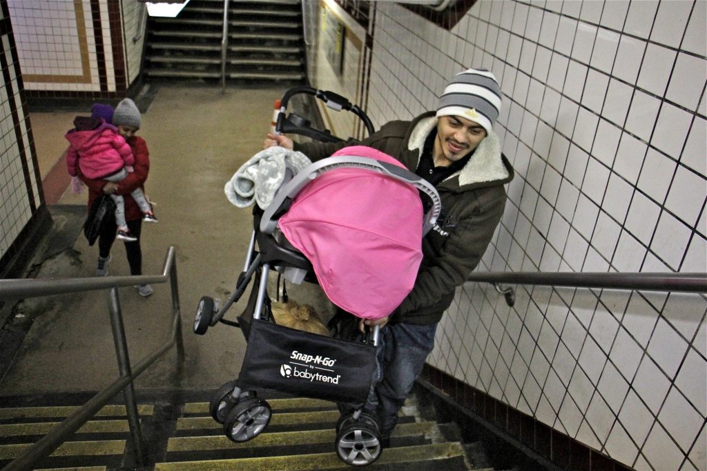 2019 02 11-e lee-philadelphia 8th and market station-septa stroller access A man carries a stroller up the stairs at the 8th and Chestnut exit from the Market Frankford line. (Emma Lee/WHYY)