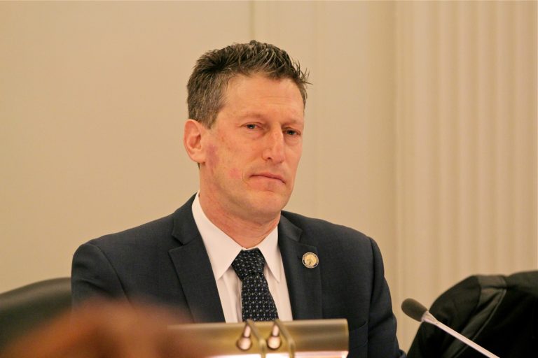 A person stands at a podium.