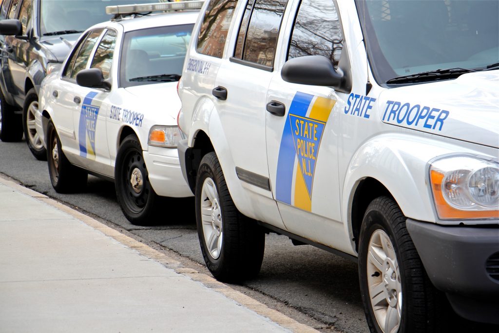 New Jersey State Police cars parked on the side of the street.