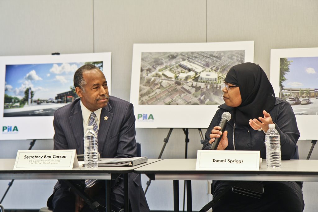 Tommi Spriggs tells her story to Ben Carson, the U.S. Secretary of Housing and Urban Development. (Kimberly Paynter/WHYY)