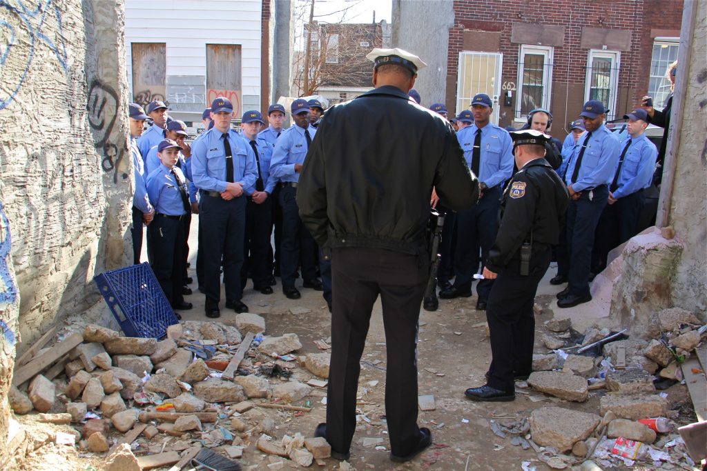 2019 02 15-e lee-philadelphia kensington-policing the opioid epidemic A group of Philadelphia police cadets, touring drug torn Kensington, gather at a vacant lot on East Lippincott Street where their instructors show them signs that heroin is being used there.