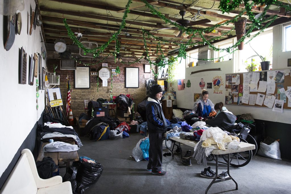 2019 02 17-r wisniewski-lou michelle-the last stop kensington Lou (left) and Michelle (center) organize donated clothes so that community members can more easily pick through them on Feb. 17. The Last Stop is a recovery clubhouse that gives donated clothes to the community each weekend. (Rachel Wisniewski for WHYY)