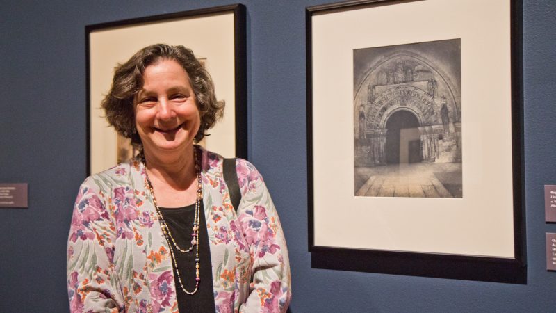 Collector Judy Hochberg with Gustave Le Gray and Auguste Mestral’s photograph of the West Portal of the church of Saint-Ours Loches, a blue-toned salt print, 1851. (Kimberly Paynter/WHYY)