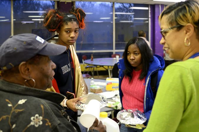 Coach Lurline Jones describes how Lankenau HS ninth-grade La’Kye Powell (2nd from right) acts on the court as members of the girls basketball team from MLK and Lankenau High Schools gather for an end-of-year banquet at the cafeteria of MLK HS, in Northwest Philadelphia, Pa., on February 19, 2019. (Bastiaan Slabbers for WHYY)