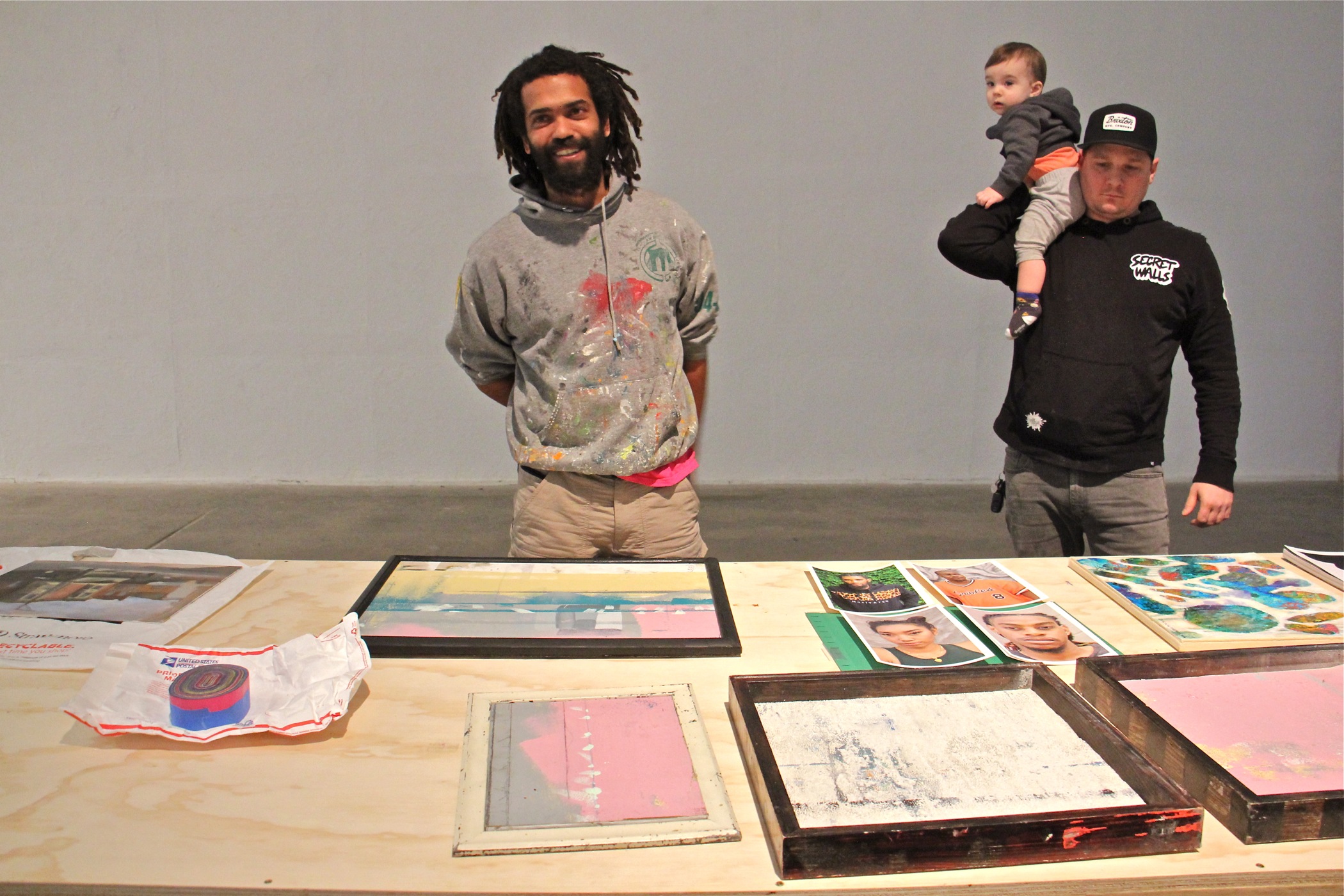 Keir Johnston (left), of the Philadelphia arts collective Amber Art and Design, collects donated works of art that will be sold to benefit the family of Willis "Nomo" Humphrey, who died in November at age 44. He is joined by Philadelphia artist Ben Howard, who dropped off some donated works at the Crane Arts Building.
