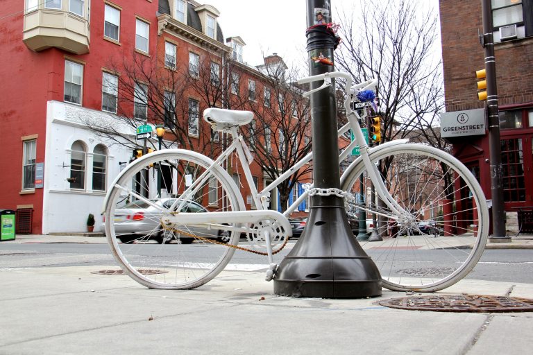 A white bike marks the corner at 11th and Spruce streets where cyclist Emily Fredricks was killed in 2017 (Emma Lee/WHYY)